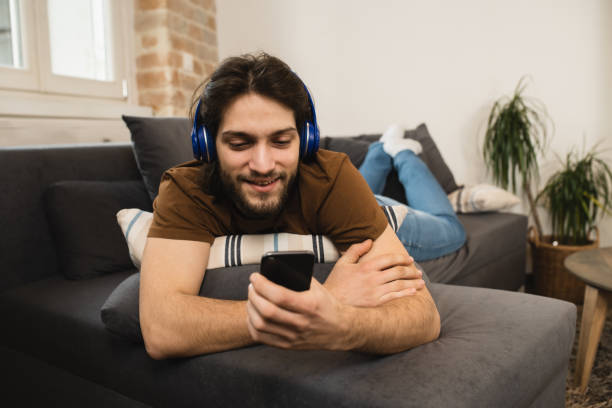 istock Excited man enjoying music at home 1455846456