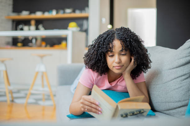 istock Woman relaxing and reading a book 1455849517