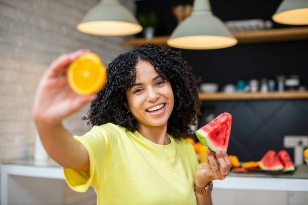 istock A young smiling woman having healthy breakfast 1455849678