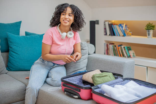 istock Young woman packing suitcase 1455849766