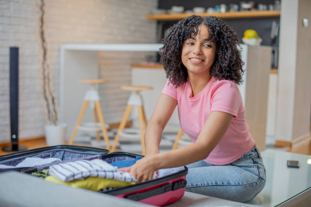 istock Woman organizing her luggage 1455849778