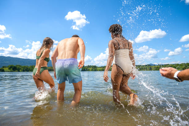 istock Friends running into the lake in sunshine 1455849983