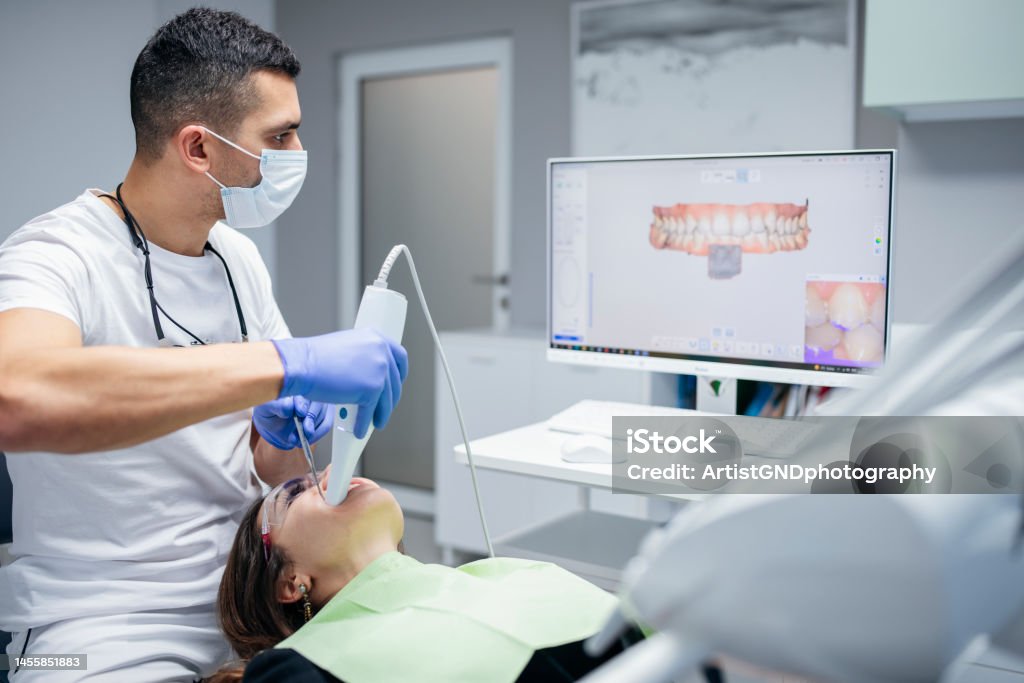 Dental procedure with the help of 3D tooth scanner technology. Young woman having her teeth scanned via 3D tooth scanner technology. Dental Health Stock Photo