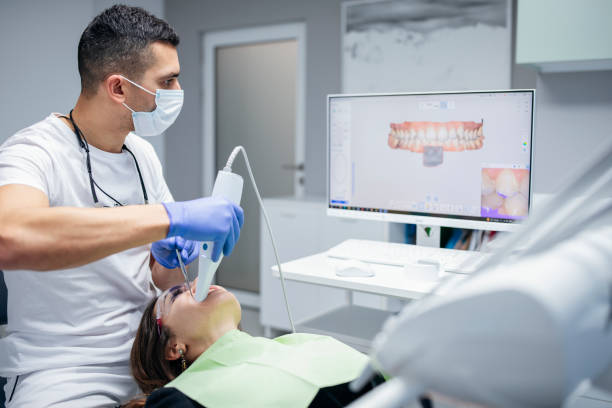 Dental procedure with the help of 3D tooth scanner technology. Young woman having her teeth scanned via 3D tooth scanner technology. 3d scanner dental stock pictures, royalty-free photos & images