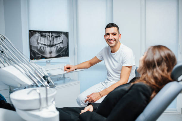 istock Dentist and his patient looking at dental X-ray. 1455851894