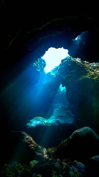 istock Underwater photo of Rays of light and sunbeam inside a cave 1455852437