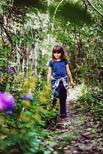 Girl on a nature walk with wildflowers