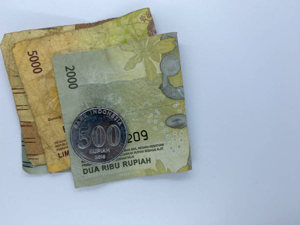 istock Indonesian dull banknotes and coin rupiah, Isolated on white background with copyspace. Rupiah is Indonesian currency 1455863872