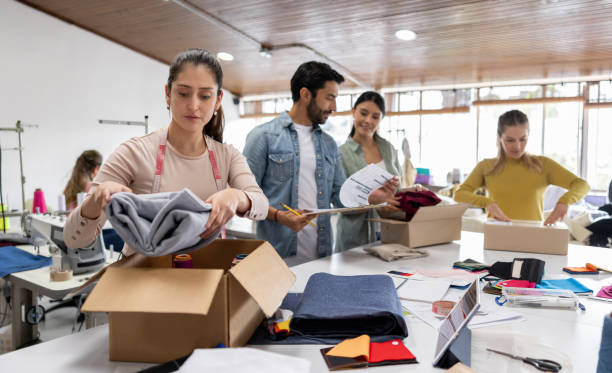 istock Team of workers sorting orders for shipping at a clothing atelier 1455864960