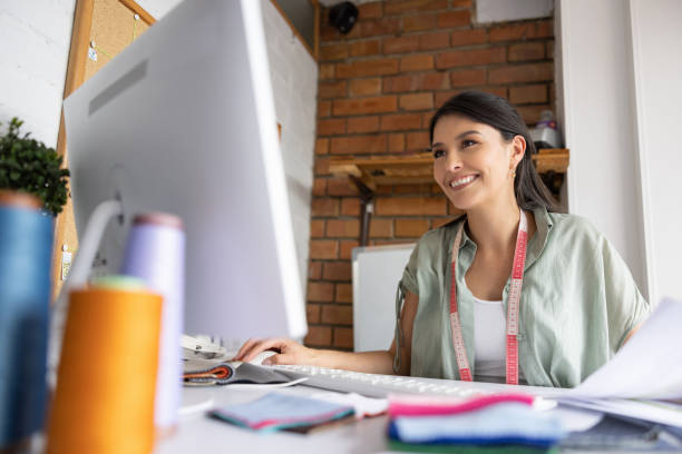 istock Fashion designer working on the computer at her design studio 1455865056