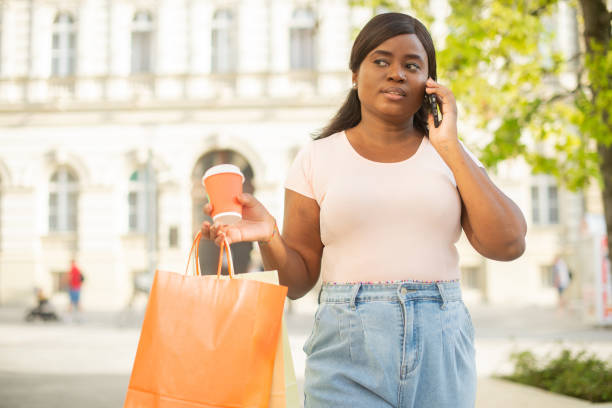 istock Young woman coming back from shopping 1455866188
