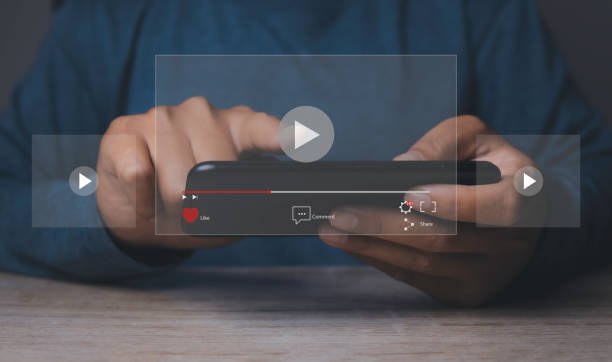 istock Person watching video on internet with an imaginary video player service. 1455867334