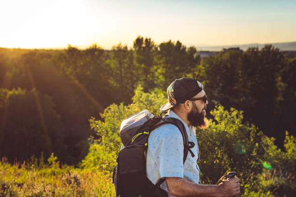 istock Man on a hike with sunflare outdoors in scenic nature 1455870027