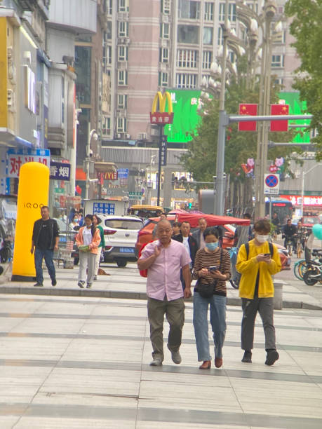 Deyang, China - Sept. 25, 2022: Crowd of people on   street in this small city.