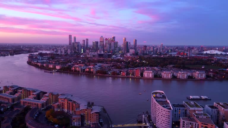 Fast FPV drone shot flying over Canary Wharf in London at twilight