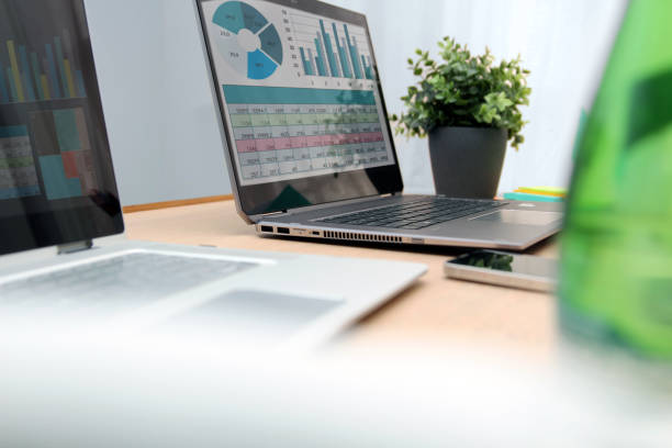 istock Working place with laptop, digital tablet; graphs on the screen 1455887485
