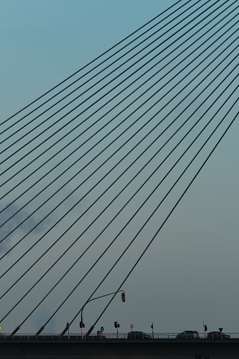 Bridge steel cable over motorway at dawn, Belgium