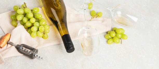 istock Glasses and bottle with white wine on a white background. 1455890315