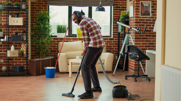 istock African american man dancing and vacuuming home floors 1455890367