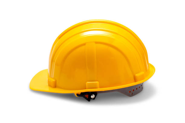 yellow deferential helmet, construction tools for industrial safety isolated on white background. hard hat worker for safe engineer labor maintenance site. protection plastic cap for builder