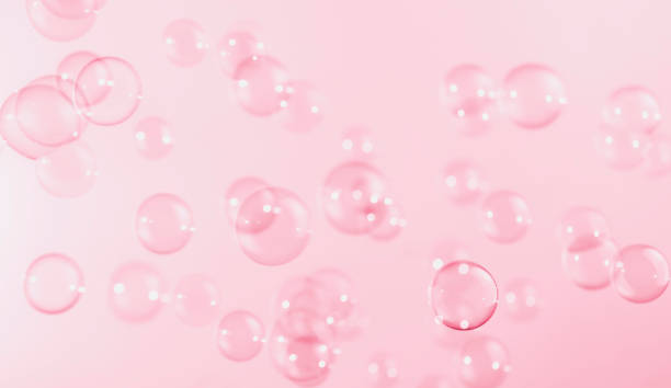 istock Abstract Beautiful Transparent Pink Soap Bubbles Background. Snowfall Defocus, Blurred Celebration, Romantic Love ValentinesTheme. Circles Bubbles. Freshness Soap Sud Bubbles Water 1455890639