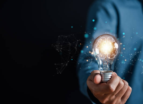 istock Hand man holding illuminated lightbulb, idea, innovation and inspiration with glowing virtual brain, smart intelligent creativity with bulbs, Motivation and innovation concept. 1455891973