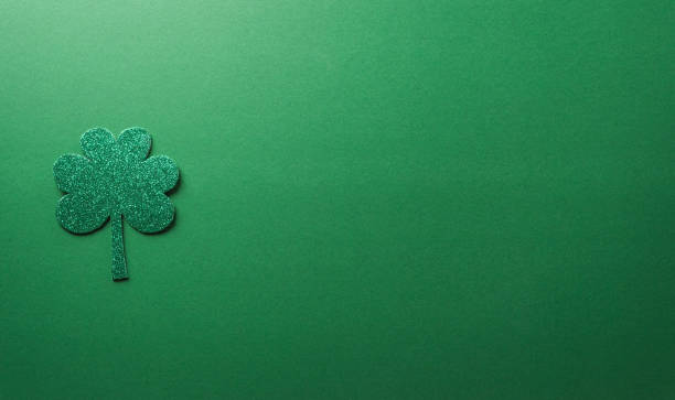 istock Happy St Patrick's Day decoration concept made from shamrocks ( clover leaf) on green background. 1455893895