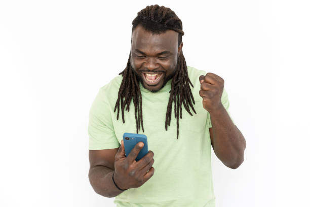 istock Happy African American man looking at phone screen 1455899014