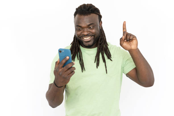 istock Man looking at phone screen and pointing up with index finger 1455899067