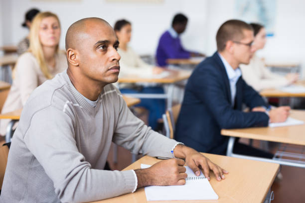 istock Focused man working at adult education class 1455901082