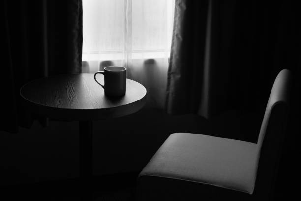 An image of a mug placed on a table by the window