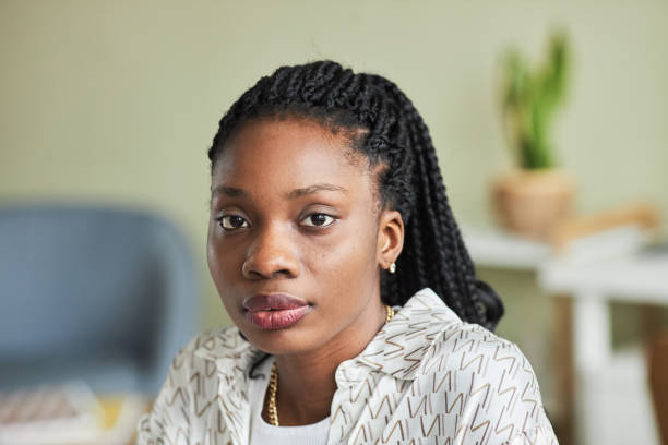 istock Close up black young woman looking at camera in minimal office 1455902605