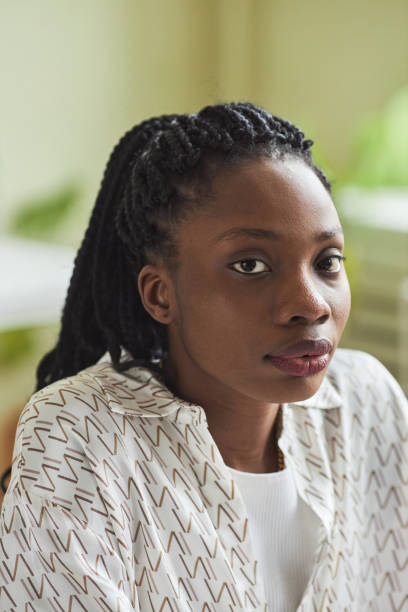istock Vertical black young woman looking at camera in office 1455902632