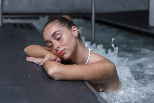 istock Relaxed woman during hydrotherapy session in pool 1455903677