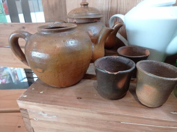 istock classic clay teapot and glass 1455904082