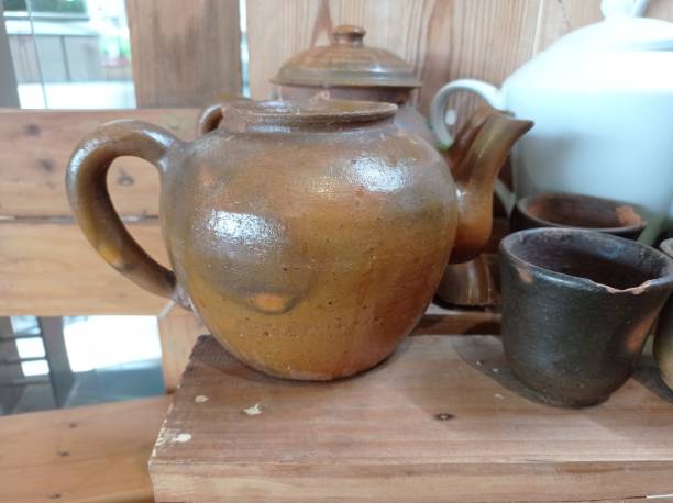 istock classic clay teapot and glass 1455904086