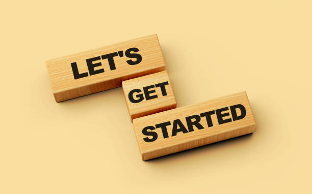 istock Wooden blocks with Let's get started word on colorful isolated background 3d illustration 1455905780