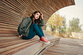 istock Autumn portrait of happy girl resting in park 1455906907