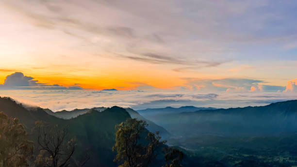 istock Foggy mountains and beautiful sunrise sky  in Bromo Tengger Semeru National Park, East Java, Indonesia. 1455906925