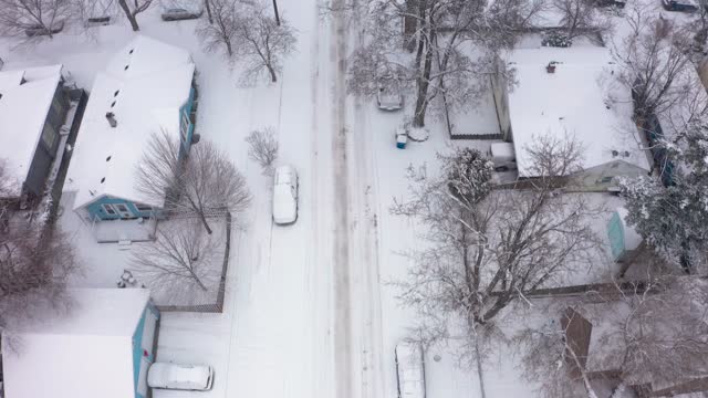 Aerial view looking down on a snow covered American neighborhood.