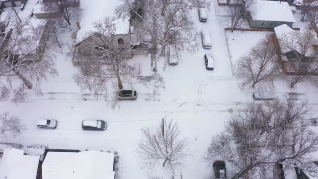 Overhead aerial view of a middle class American neighborhood covered in a blanket of snow.