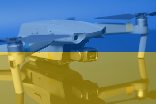 Double exposure of Flag of Ukraine and quadcopter drone aerial camera..