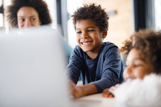 istock Happy African American boy using laptop at home. 1455912412