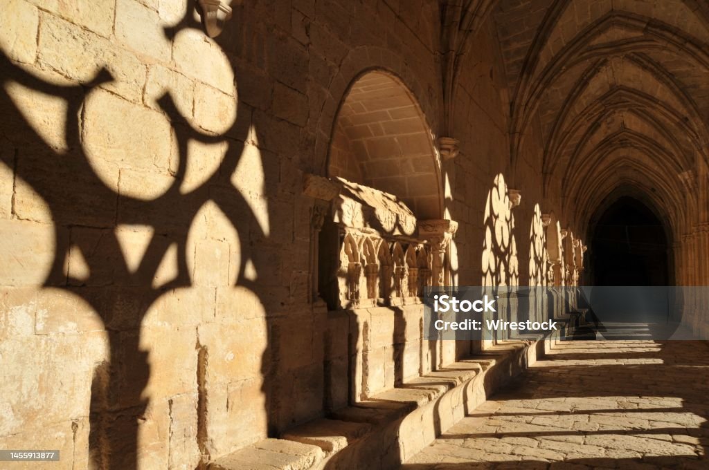 Cloister of the Fontfroide Abbey with shadows on the wall, Languedoc-Roussillon, France The cloister of the Fontfroide Abbey with shadows on the wall, Languedoc-Roussillon, France Ancient Stock Photo