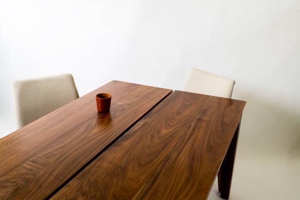istock Wooden table, two chairs and a cup, placed on the table against a white background 1455916270