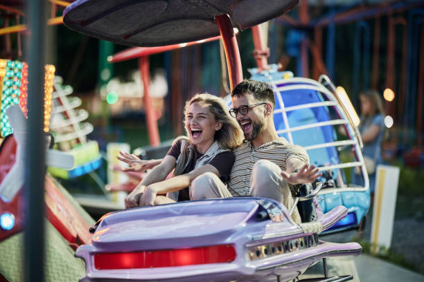 istock Cheerful couple having fun during amusement park ride. 1455916346