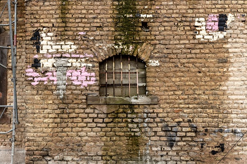 Close-up shot of a bricked-up window of an abandoned building