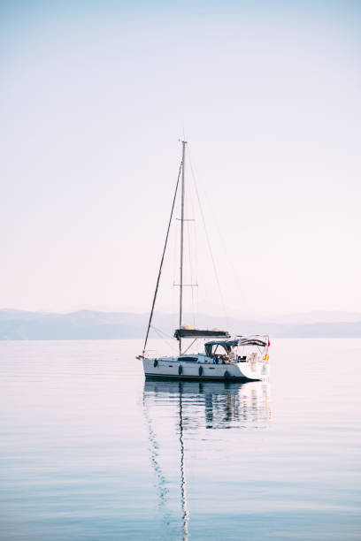 Sailing Boat in the Still Sea