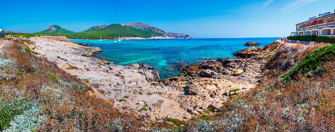 A panoramic view of the Cala Agulla Beach on a sunny day in Majorca, Spain