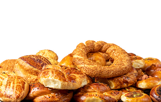 Assortment of bagels and pogaca isolated on a white background. They eat pastries in piles. Bakery products. Traditional turkish cuisine breakfast culture. Local name simit, pogaca, borek, acma
